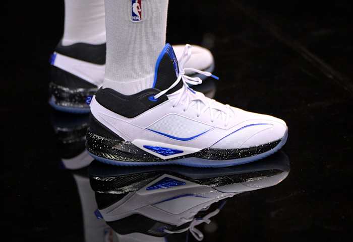 Los Angeles Clippers forward Kawhi Leonard's white, black, and blue New Balance shoes.